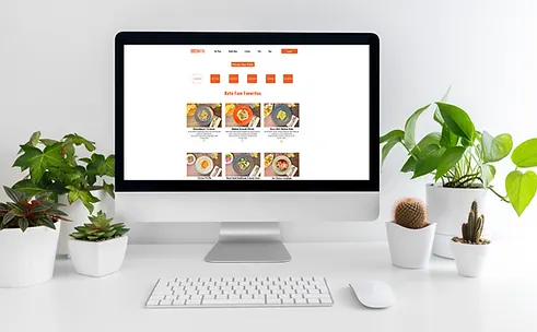 Screenshot of Club Keto Meal Prep website homepage featuring a vibrant array of low-carb meal options and subscription plans